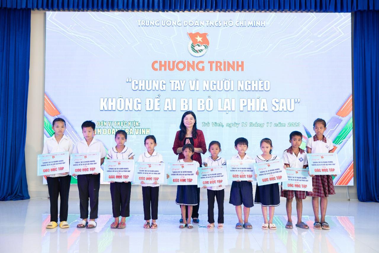 A group of children standing in front of a stage

Description automatically generated