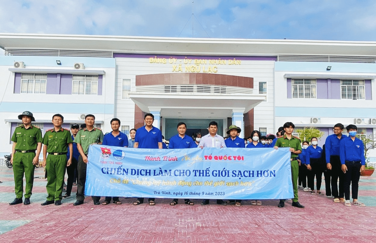 A group of people holding a banner
Description automatically generated