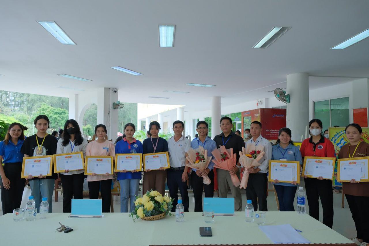 A group of people holding certificates Description automatically generated