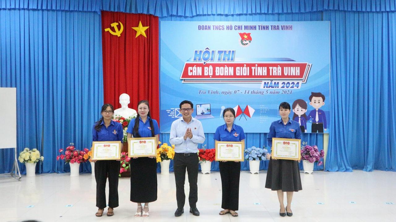 A group of people holding certificates Description automatically generated