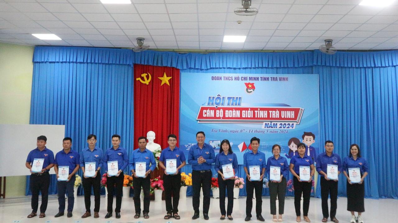 A group of people holding signs Description automatically generated