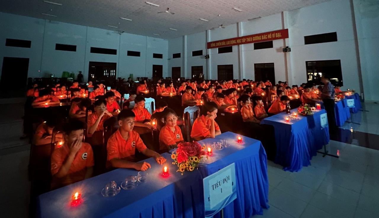 A group of people in a room Description automatically generated with low confidence