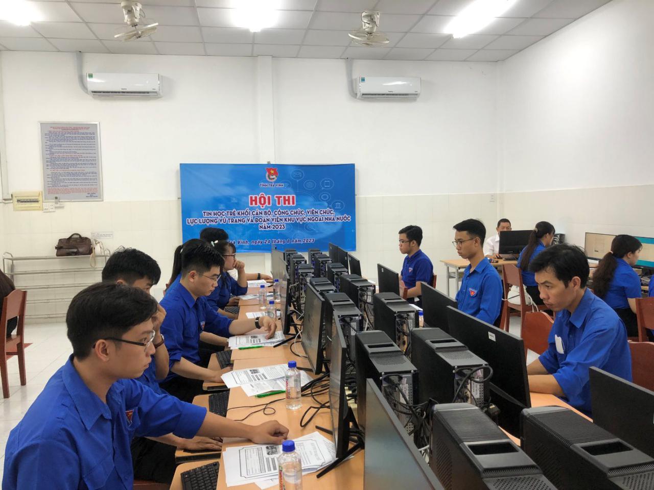 A group of people sitting at computers
Description automatically generated