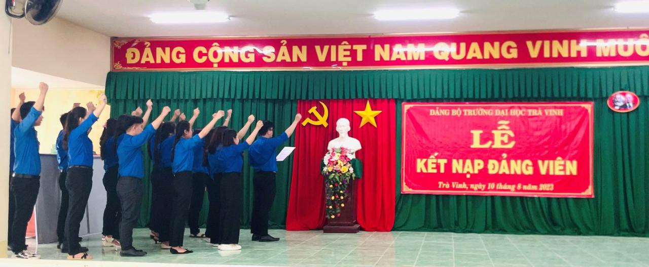 A group of people standing in front of a statue Description automatically generated