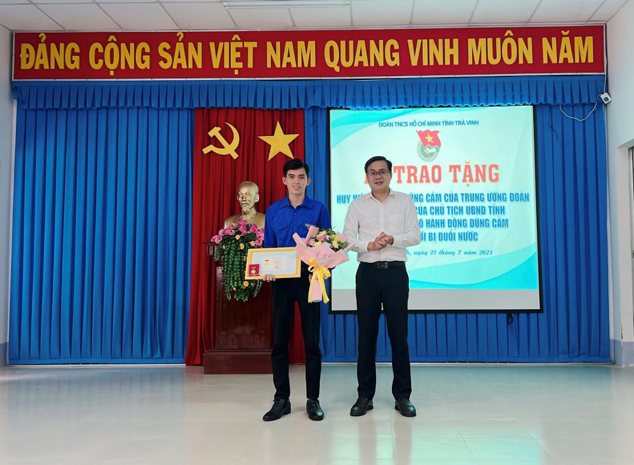 Two men standing on a stage

Description automatically generated