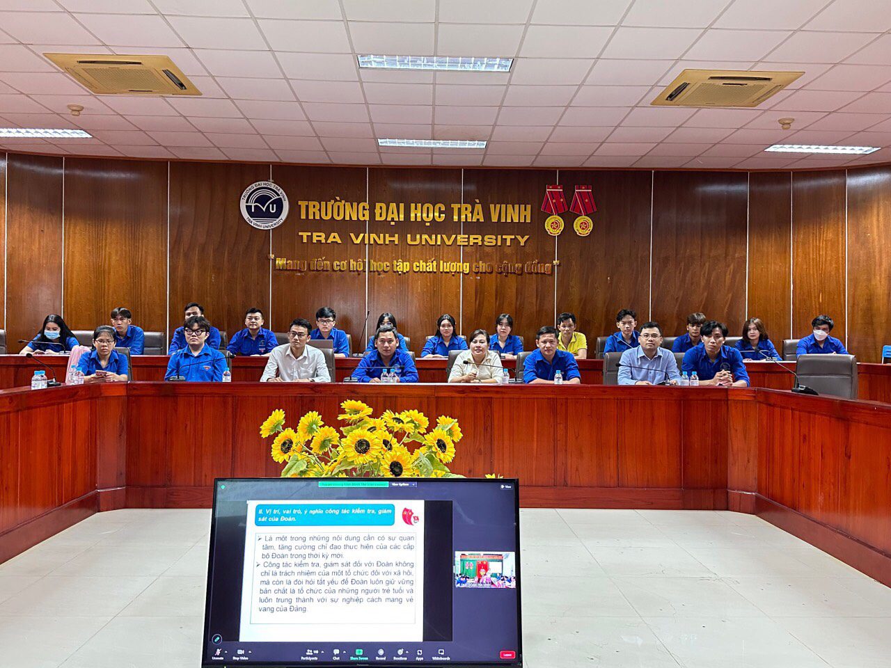 A group of people sitting at a podium Description automatically generated with low confidence