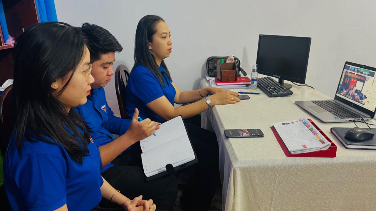 A group of women looking at a paper Description automatically generated with low confidence