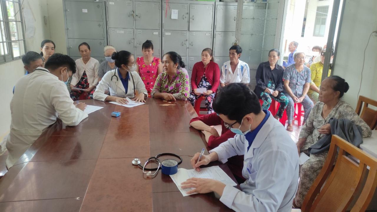 A group of people sitting around a table Description automatically generated