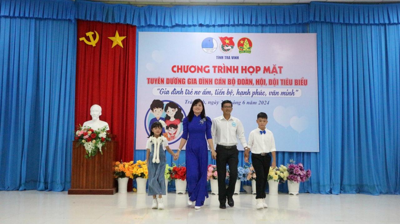 A group of people walking on a stage Description automatically generated