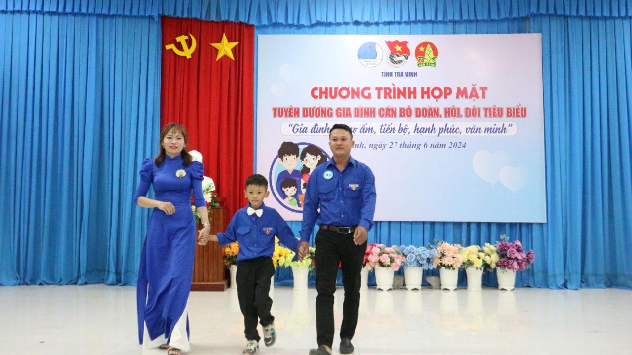 A group of people walking on a stage Description automatically generated