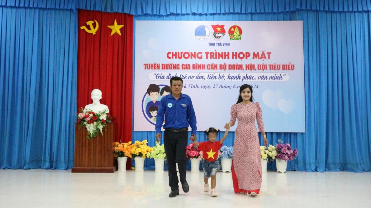 A group of people walking on a stage Description automatically generated