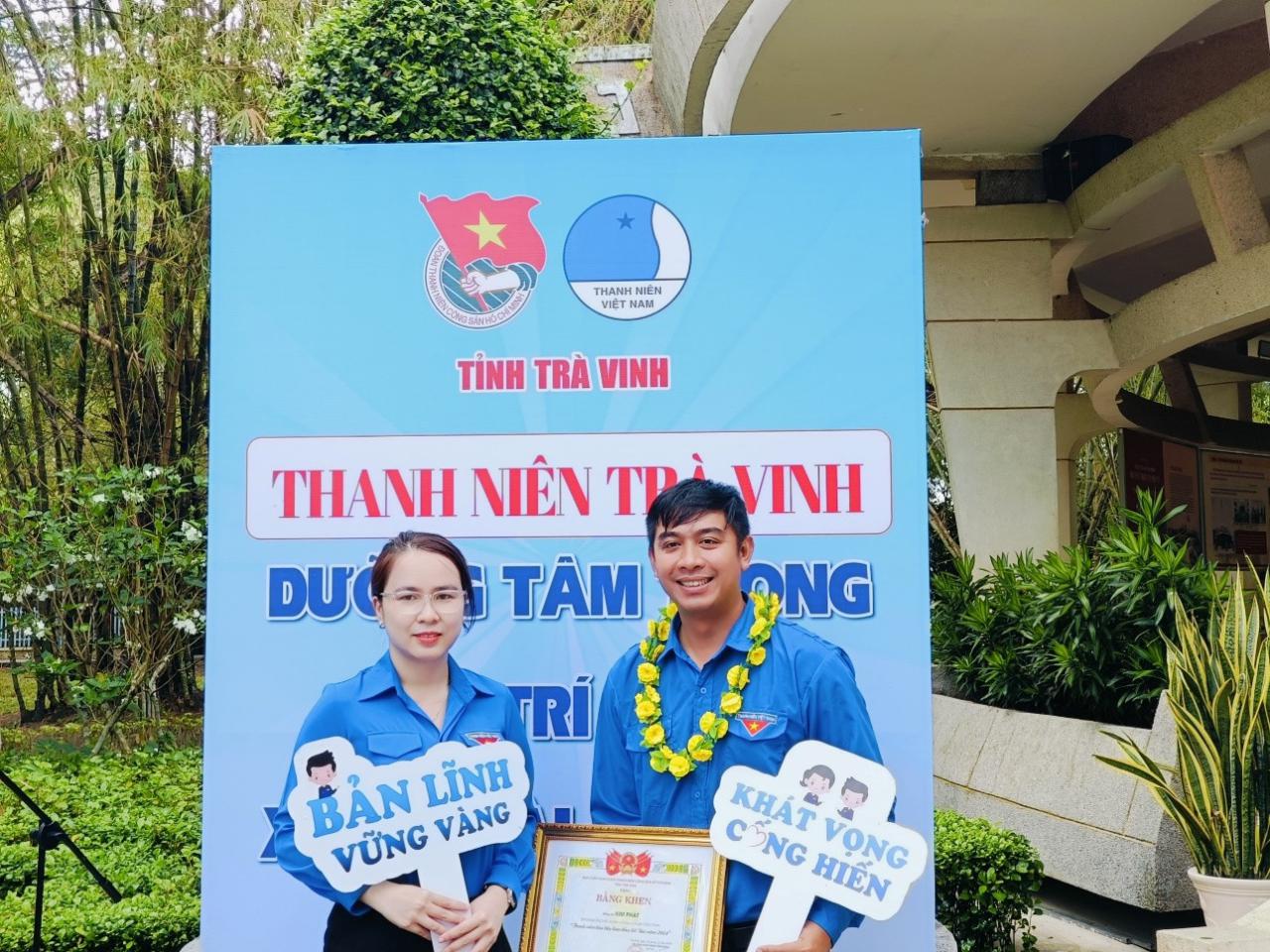 A person and person standing in front of a sign

Description automatically generated