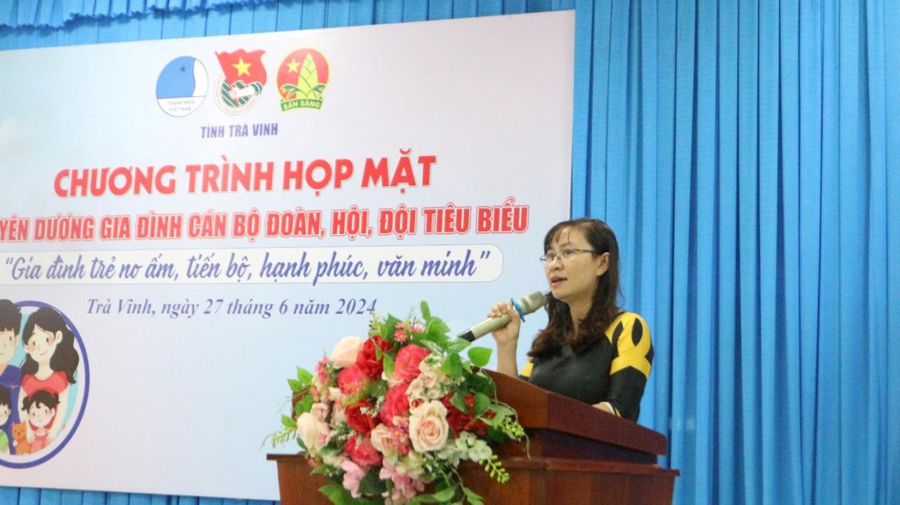 A person speaking into a microphone Description automatically generated