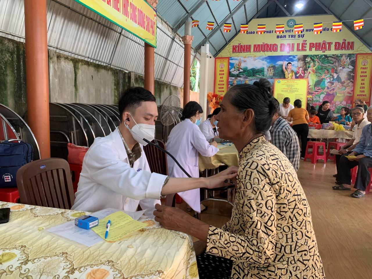 A person wearing a mask and sitting at a table with a person in a mask Description automatically generated