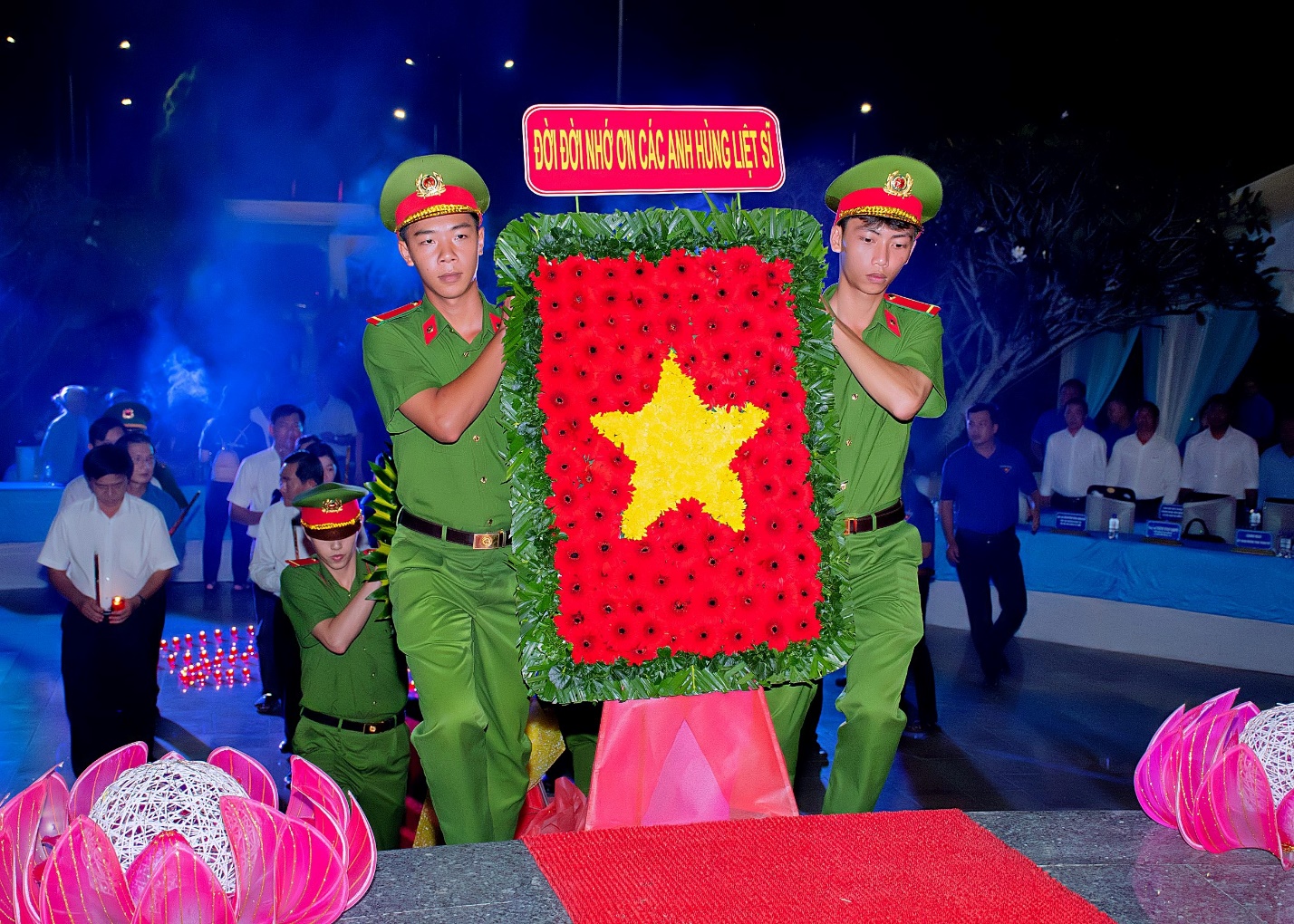 A group of men in green uniforms Description automatically generated