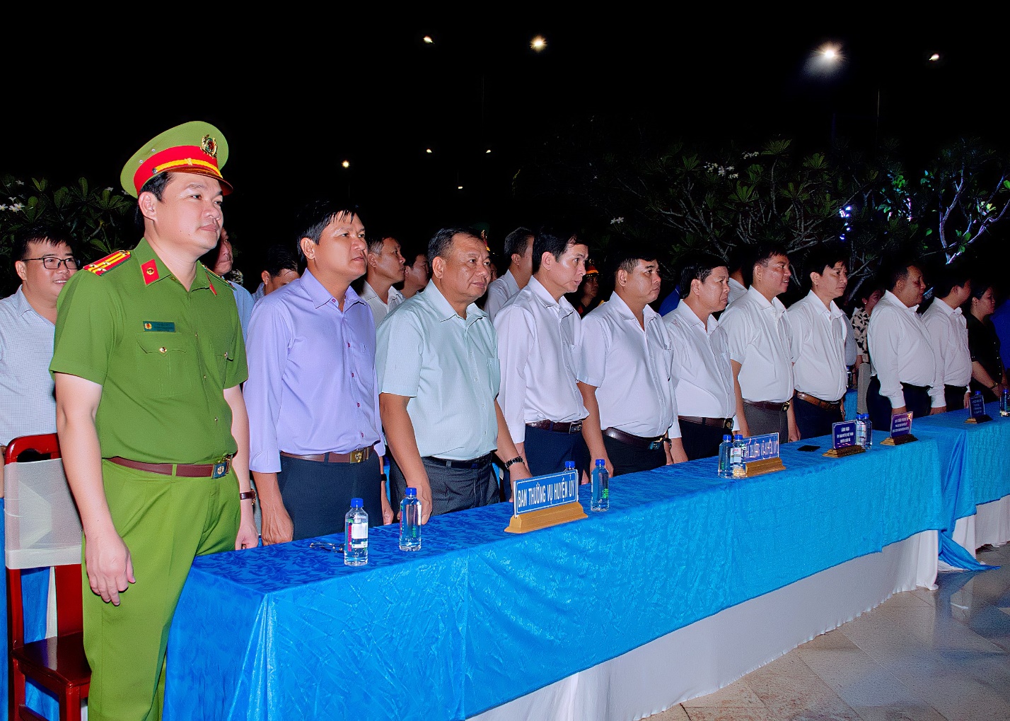 A group of men standing in a line Description automatically generated