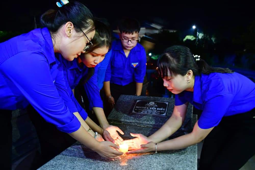 A group of people wearing blue shirts Description automatically generated