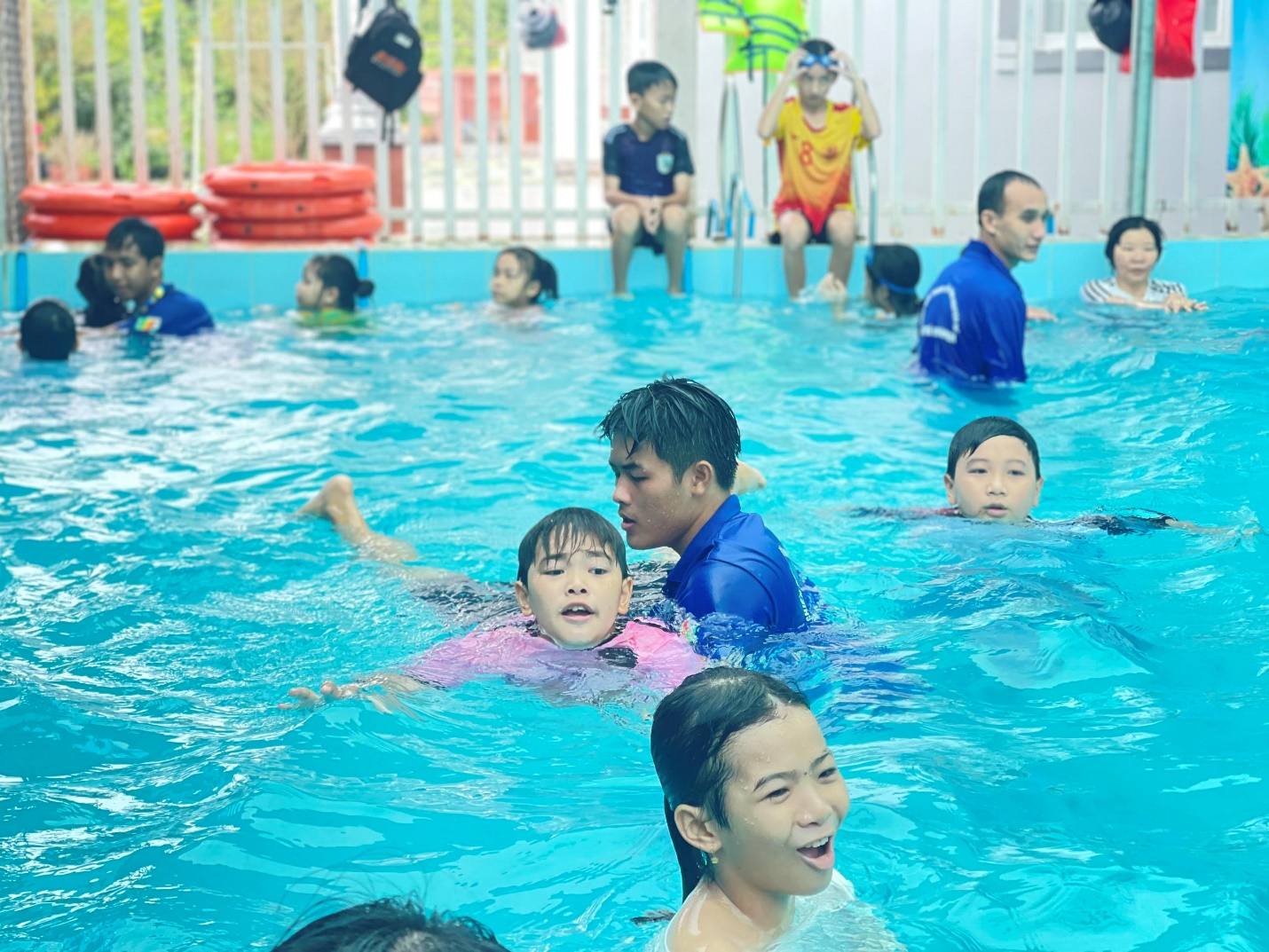 A group of people in a pool Description automatically generated