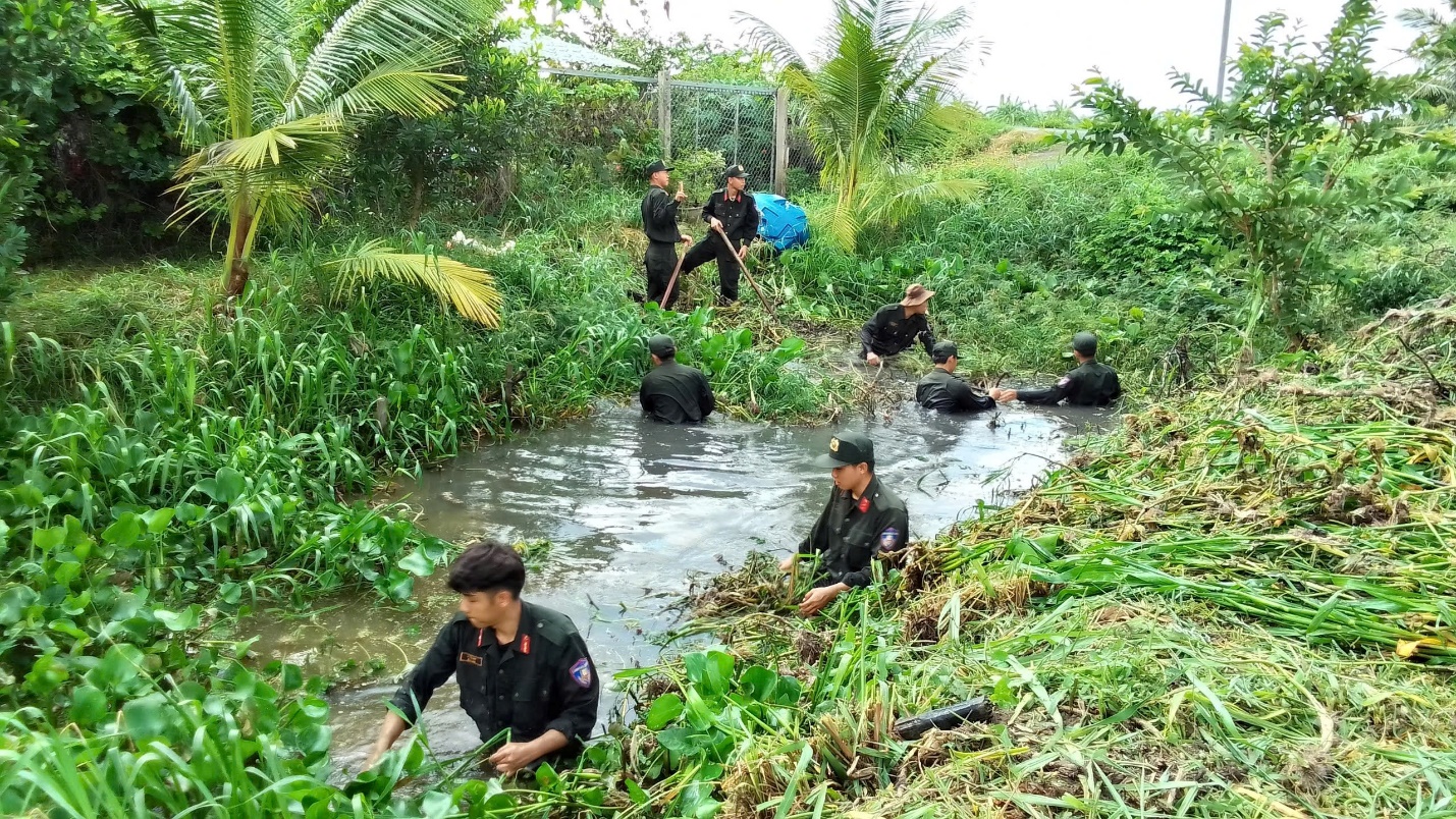 A group of people in a stream Description automatically generated