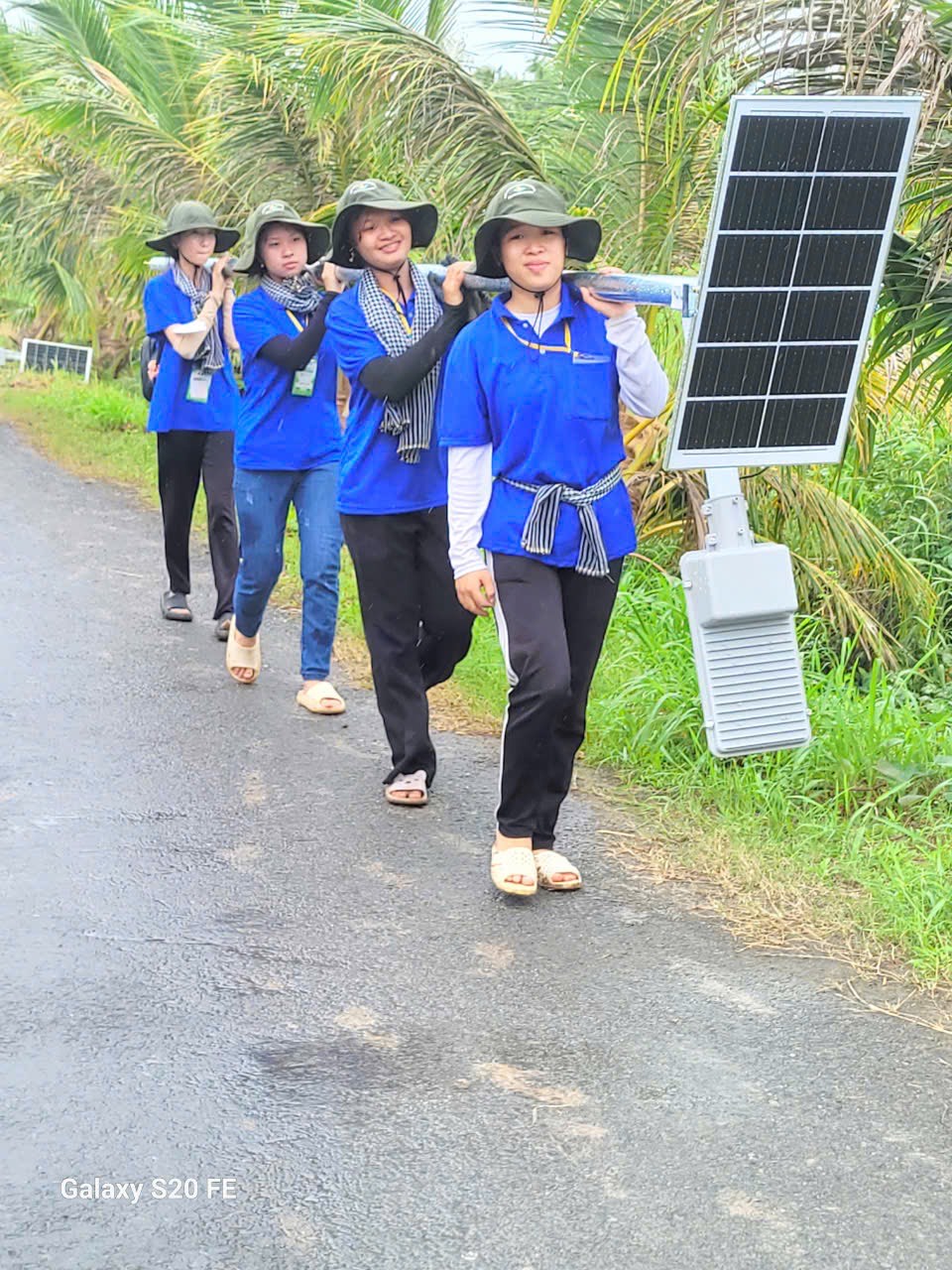 A group of people walking on a road Description automatically generated