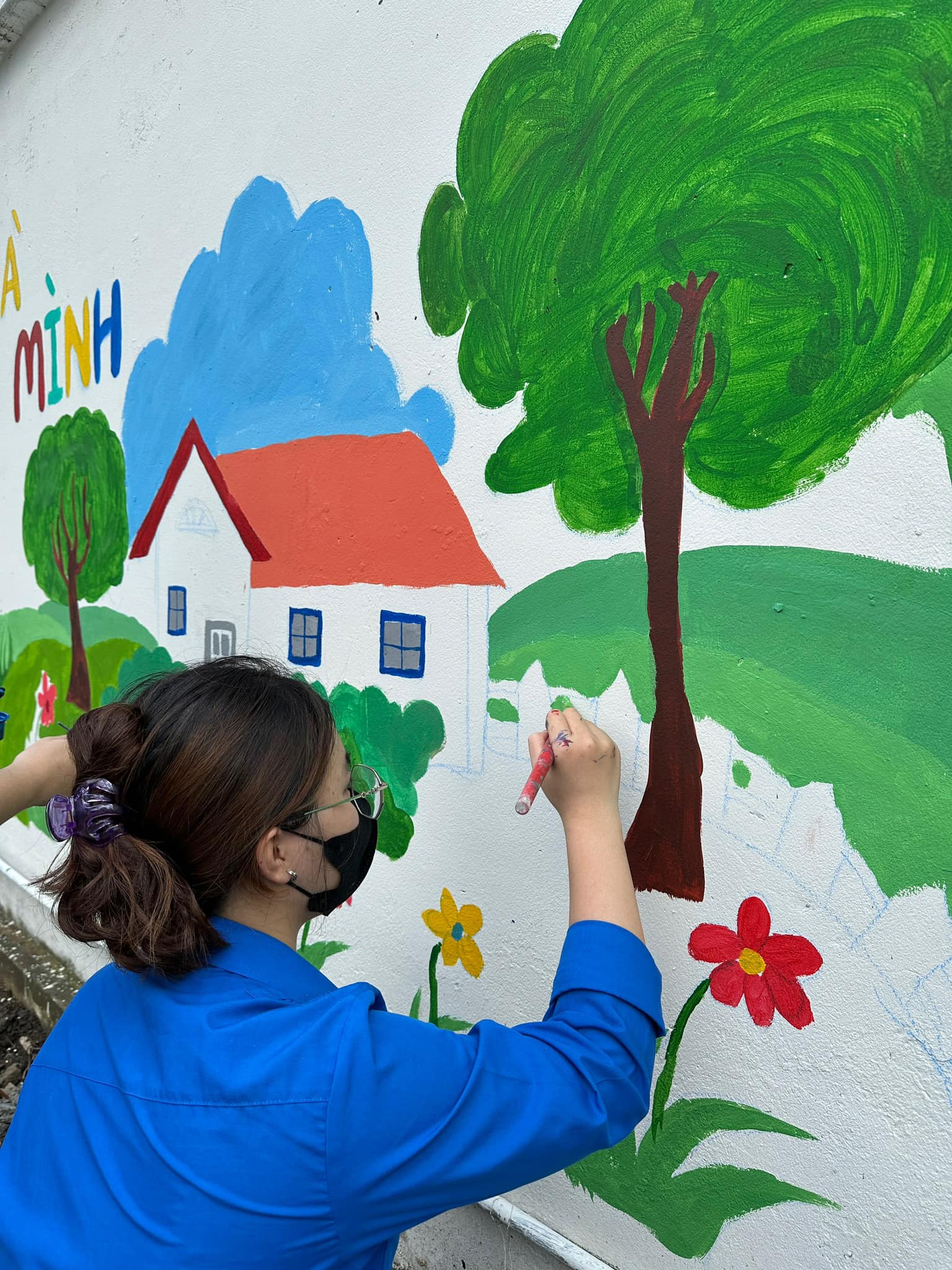 A person painting a wall Description automatically generated