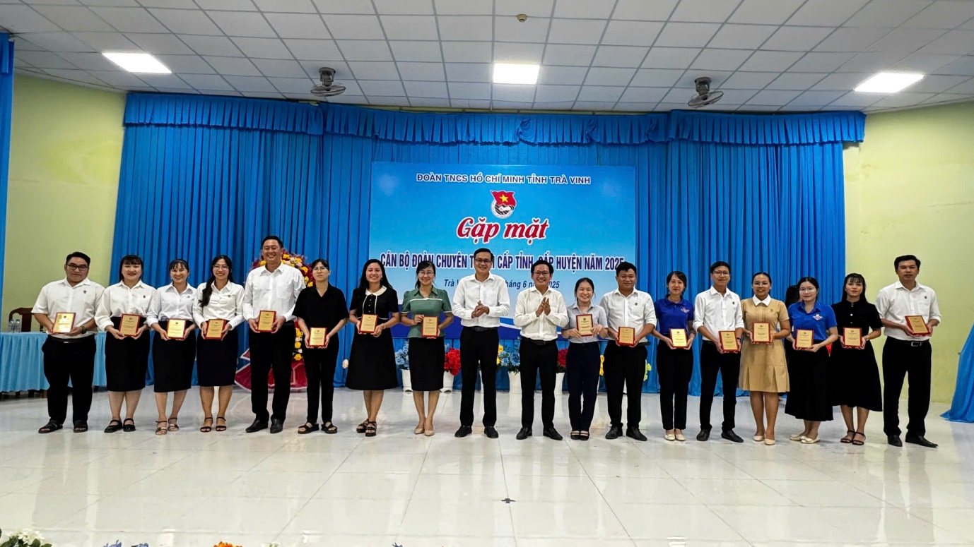 A group of people holding awards
Description automatically generated